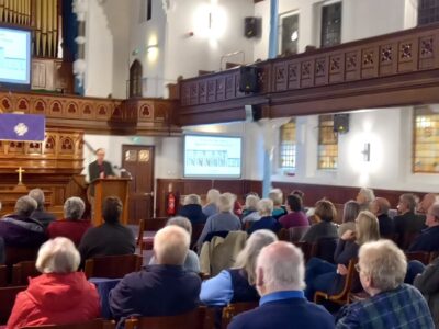 Attendees in a church listening to one of Spalding Gentlemen's Society's lectures