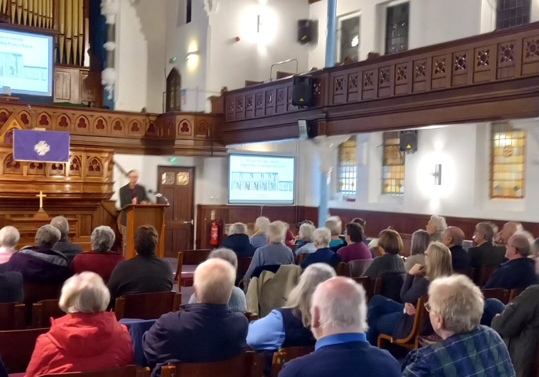 Attendees in a church listening to one of Spalding Gentlemen's Society's lectures